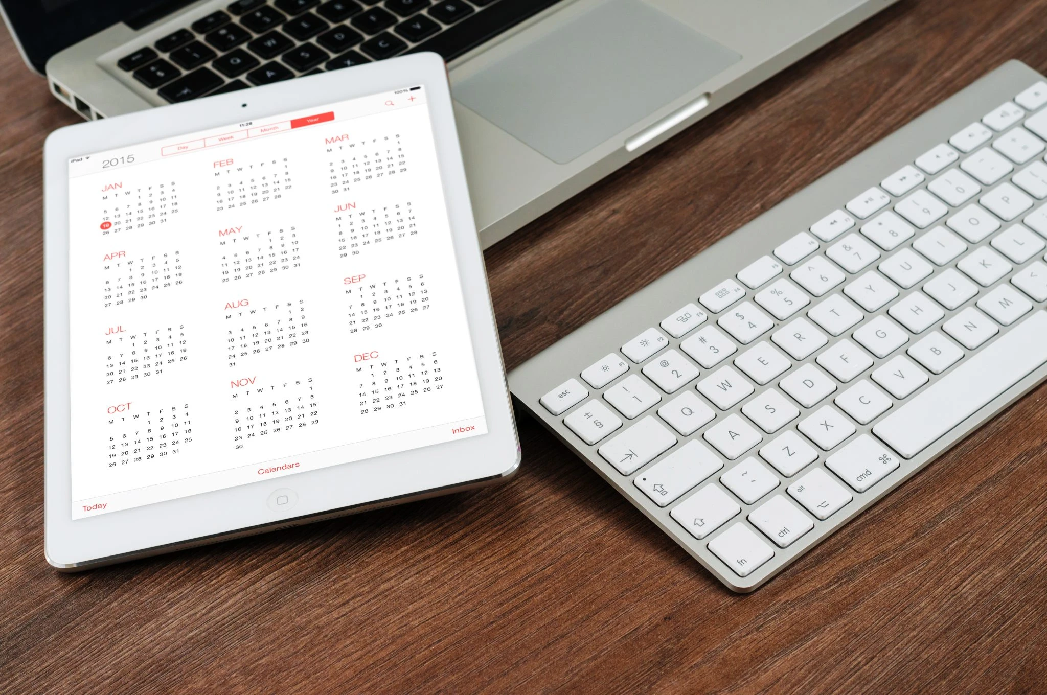 Desktop with shelf calendar and white keyboard