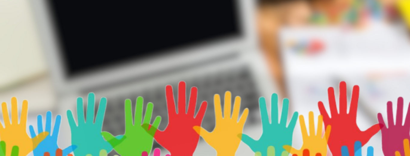 Colored hands in front of a computer for education