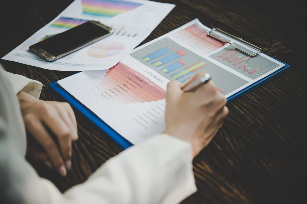 Analysis of financial charts on a wooden desk