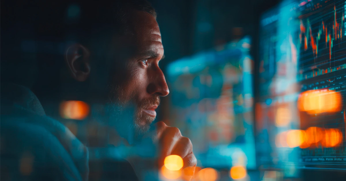 Man analyzing stock market data on screen