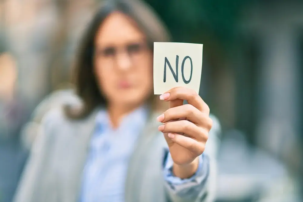 Woman holding up a 'NO' sign