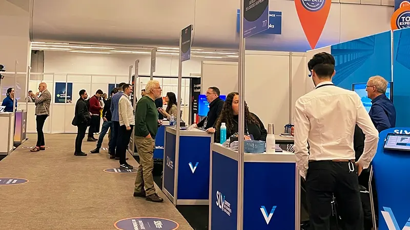 Participants talking to SLV Expert staff at their booth at the Strategies PME trade show in Montreal.