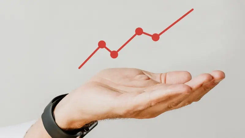 Hand supporting a red growth curve