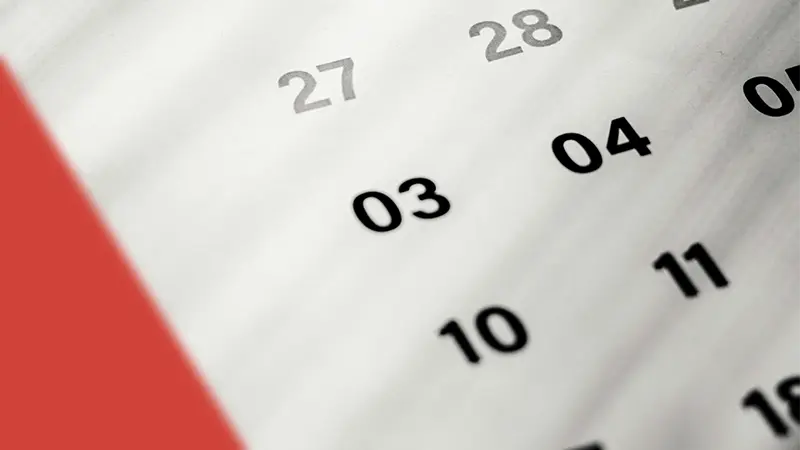 Close-up of a monthly calendar between red and white