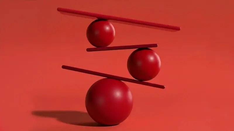 Red spheres balancing on a red background