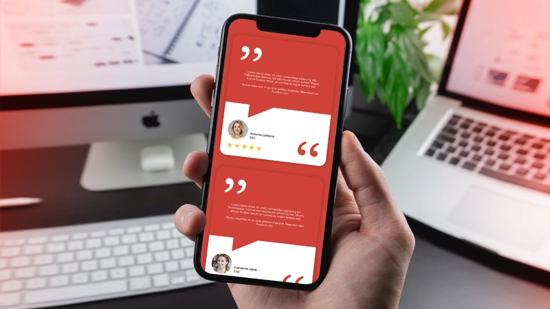 Customer reviews displayed on a smartphone, with a laptop and desktop computer in the background, complete with keyboard.