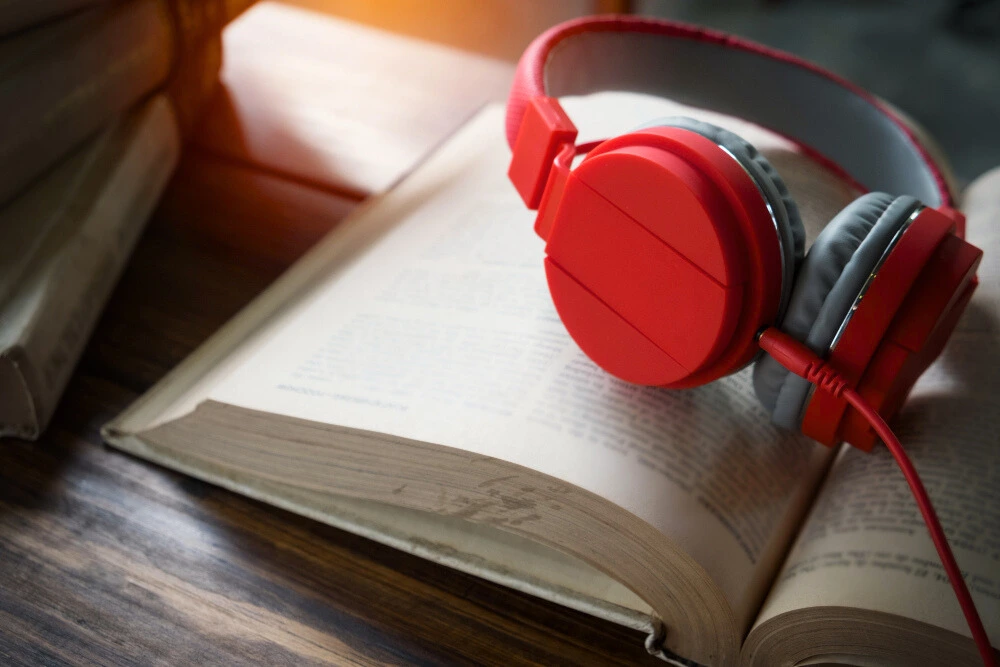Red headphones on the pages of an open book.